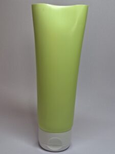 Light green cosmetic bottle-style squeeze tube with white flip-top cap, ideal for skincare and cosmetic bottles packaging.